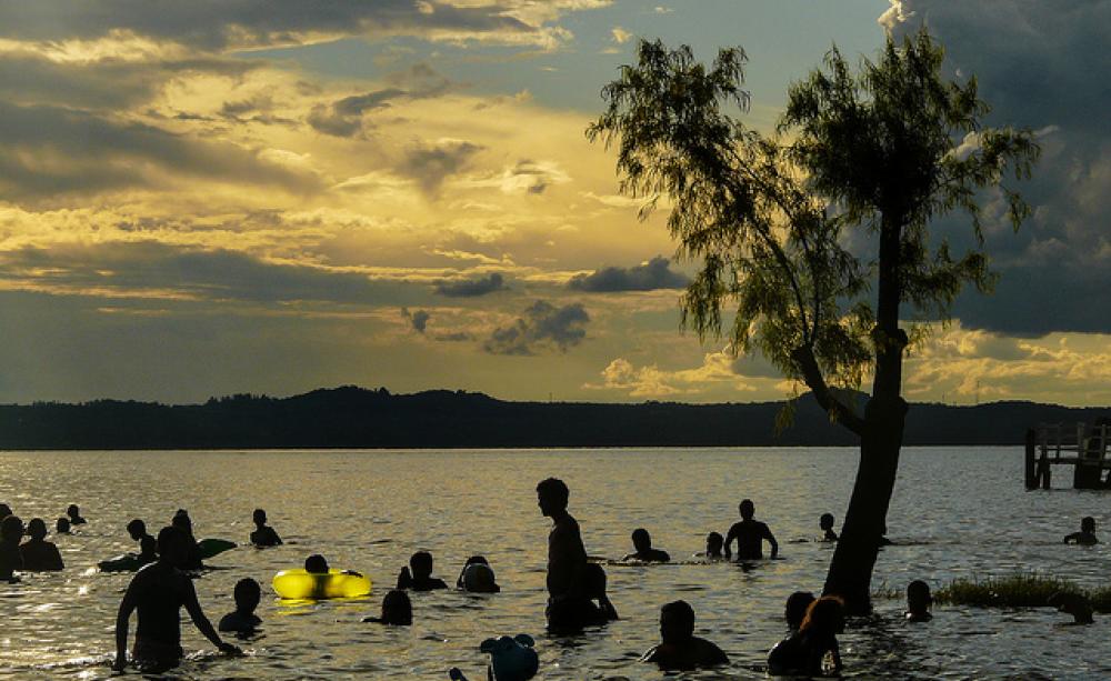 Swimmers in a late at sunset