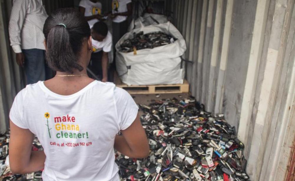Woman looks at hundreds of old mobile phones