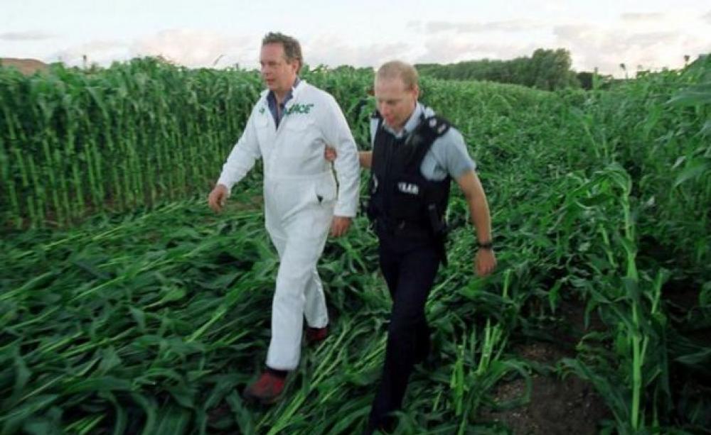Peter Melchett being led away by a police officer at GM protest