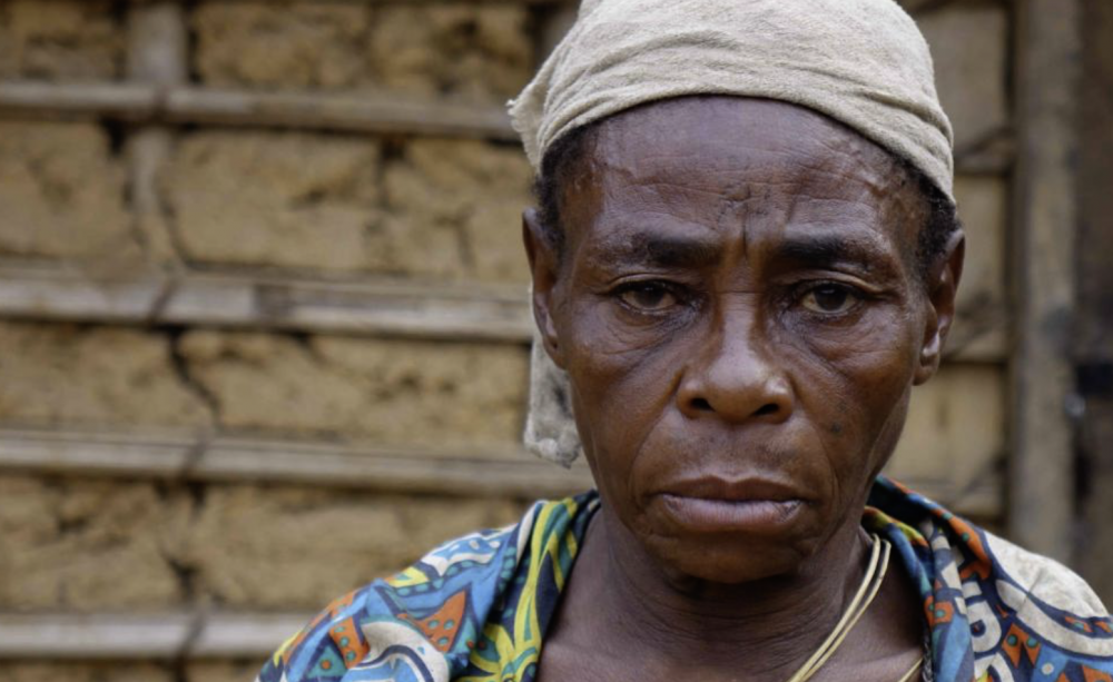 A Baka woman whose husband, named Komanda, was arrested by rangers in Messok Dja, then imprisoned on false accusations of poaching. In prison he was brutally assaulted by other prisoners, and died soon after being released.
