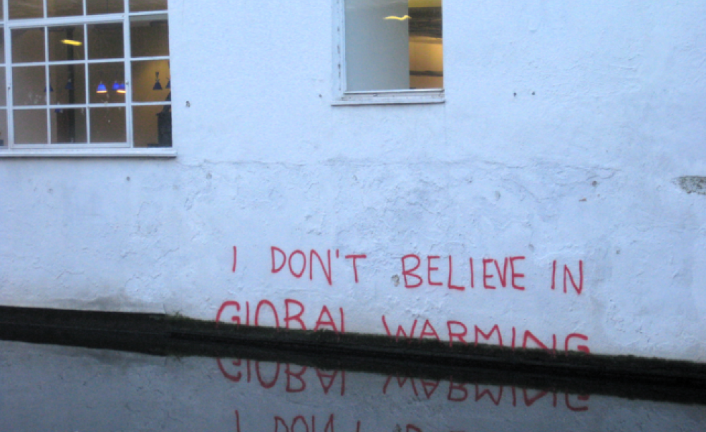 London Graffiti saying "I don't believe in global warming" sinks into water