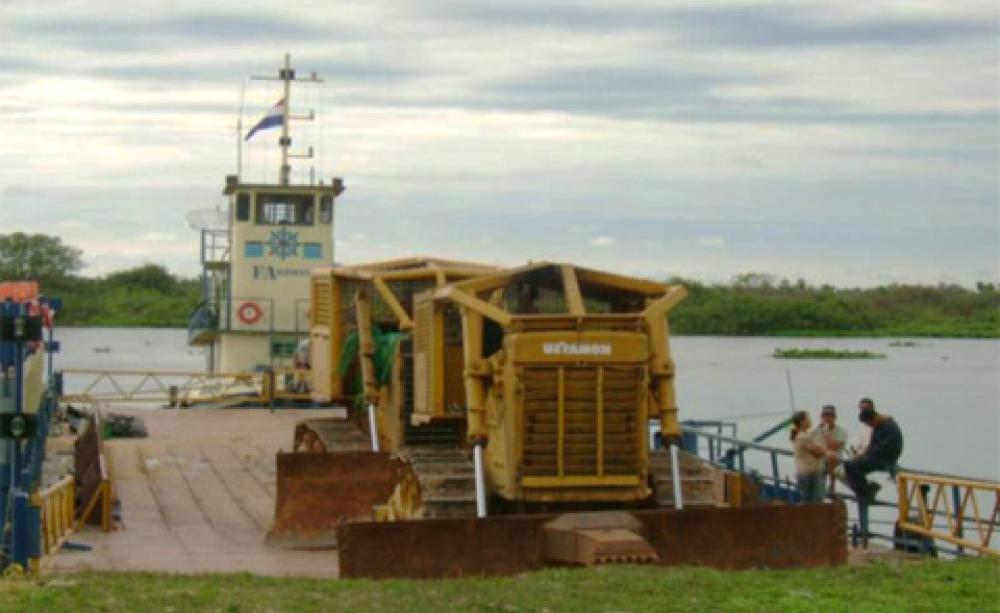 Bulldozer rolling off barge in Paraguay