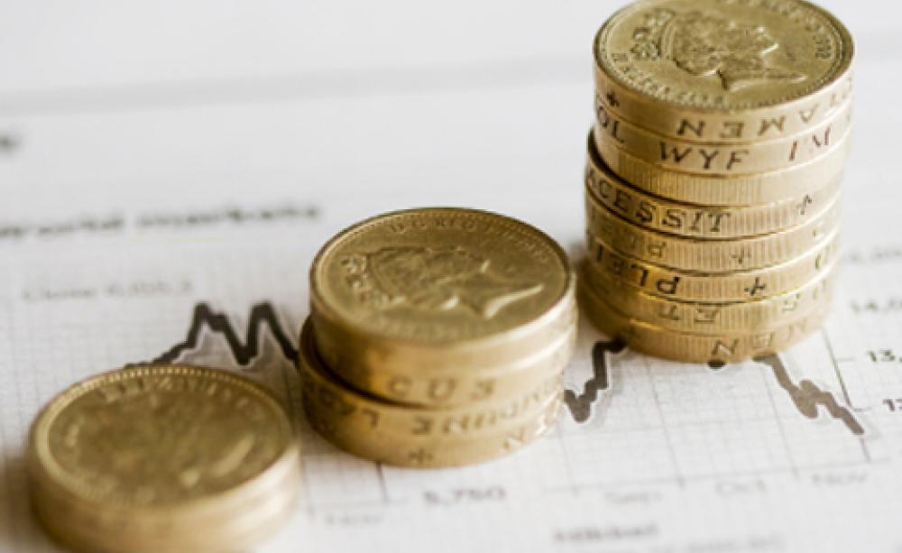 stacks of pound coins on a stock chart