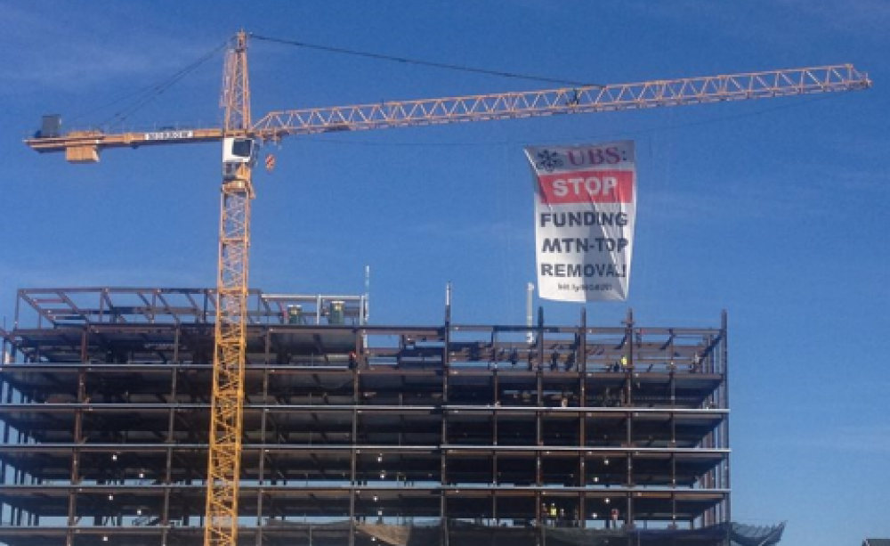 Protestors hang a giant banner to protest UBS's financing of mountain-top removal coal mining. Photo: Hands off Appalachia.