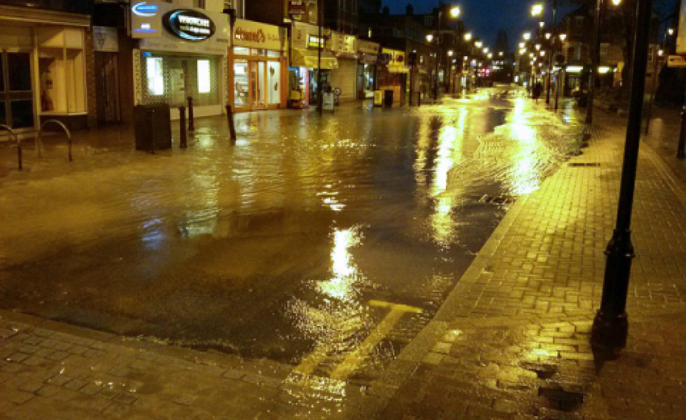 Going to waste ... a burst water main in Wealdstone, Harrow, 7th Feb 2014. Photo: timku via Flickr.com.