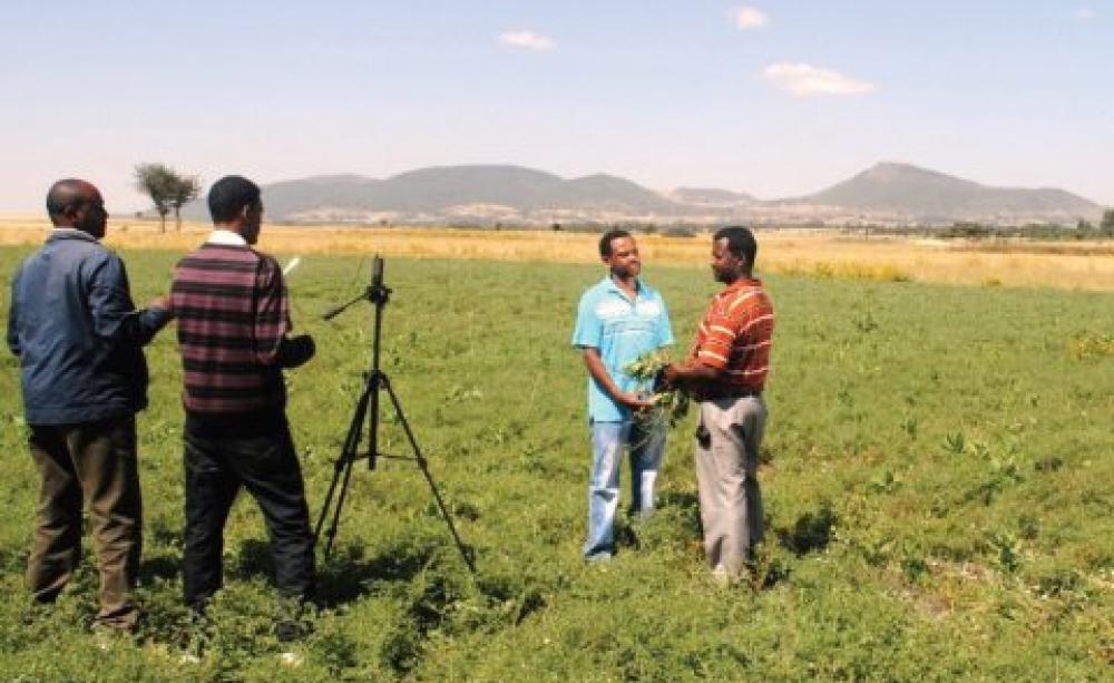 Digital Green records a discussion on best agronomic practice with an Ethiopian farmer for dissemination among his peers. Photo: Digital Green.