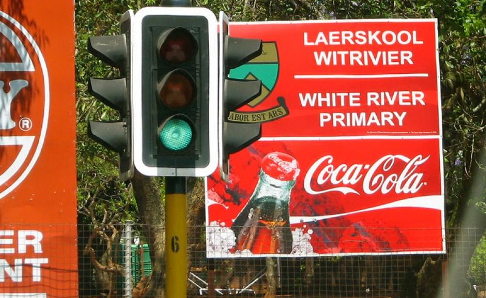 The education and health care model that British taxpayers are financing across Africa - in partnership with for-profit multinational corporations. Photo of White River Primary school, sponsored by Coca-Cola, by Roo Reynolds via Flickr (CC BY-NC).