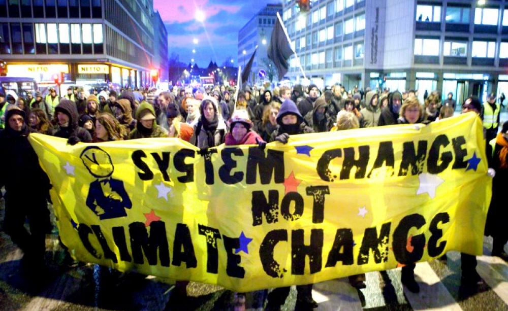 'System change not climate change' banner at the 2009 COP15 UN climate talks in Copenhagen, Denmark. Will Paris be any more successful? Photo: kris krüg via Flickr (CC BY-NC-ND).