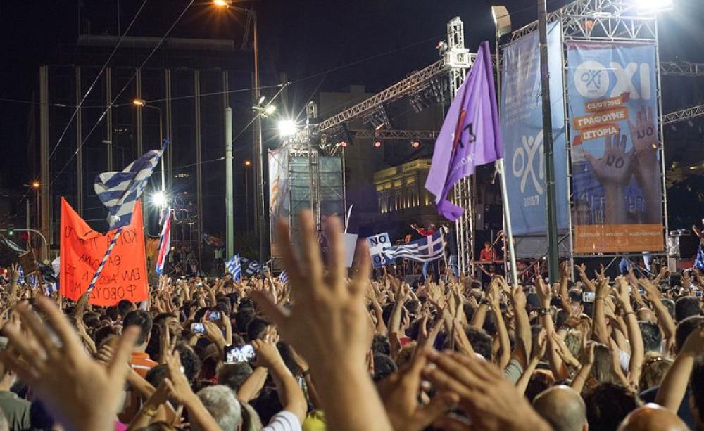 OXI! Before the Greek referendum, on 3rd July 2015,  thousands gather to campaign for a NO vote in Syntagma square, Athens, Greece. Photo: Ggia via Wikimedia Commons (CC BY-SA).