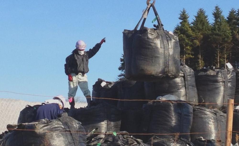 Contaminated earth storage area within the Iitate Village evacuated zone, December 2014. Photo: Eric Schultz / EELV Fukushima via Flickr (CC BY-NC-SA).