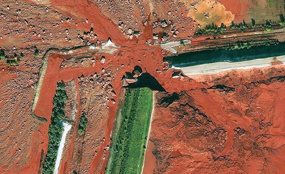 Farmland is inundated with toxic red mud following the 2010 Ajka alumina plant accident, in Hungary, which injured hundreds and killed ten. Photo: public domain.