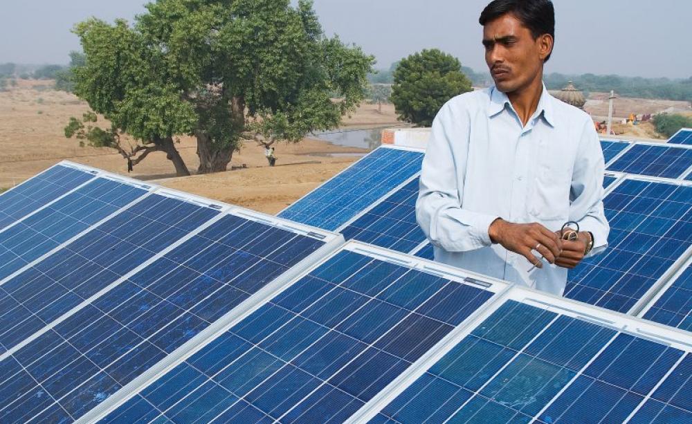 From small beginnings ... local barefoot solar engineer cleaning PV panels in village outside Ajmer, Rajasthan, India, in December 2008. Photo: Knut-Erik Helle via Flickr (CC BY-NC-ND)