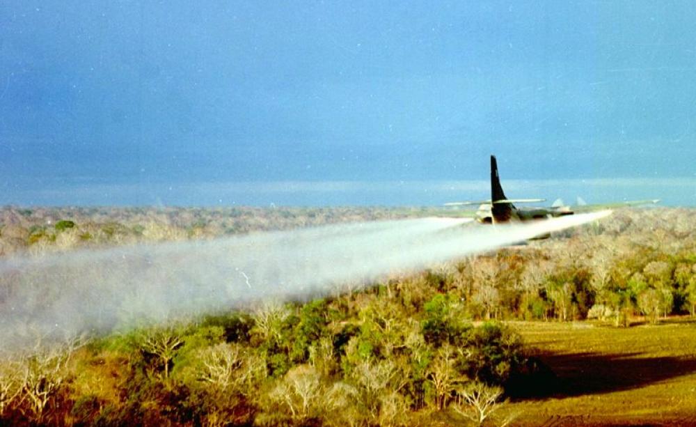 A US Air Force Fairchild UC-123B Provider C-123 Ranch Hand aircraft sprays defoliant over the target area of Operation Pink Rose in January 1967. Photo: US Air Force via Wikimedia (Public Domain).