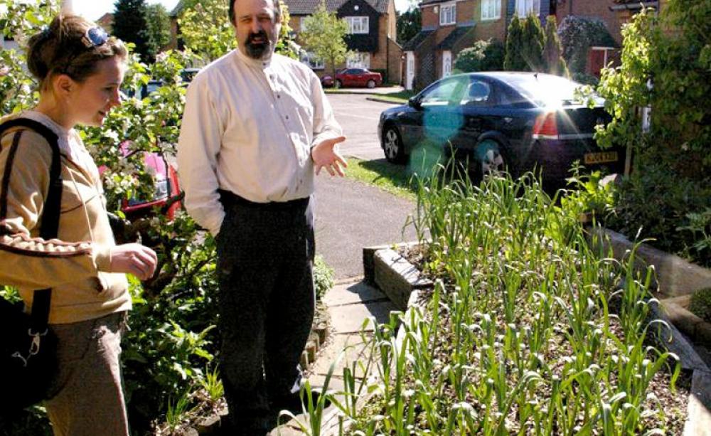Mike Guerra explains his permaculture garden to Louise Parry