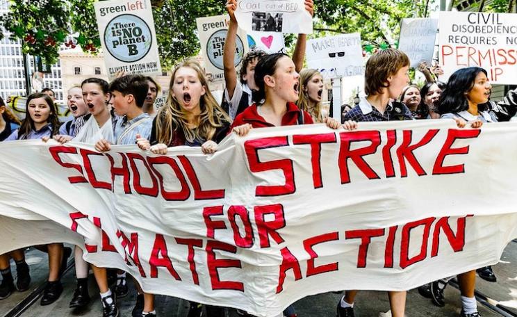 school children with strike action banner