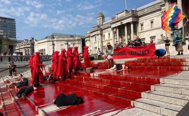 Extinction Rebellion pour blood on the steps of Trafalgar Square to highlight the crisis in Brazil