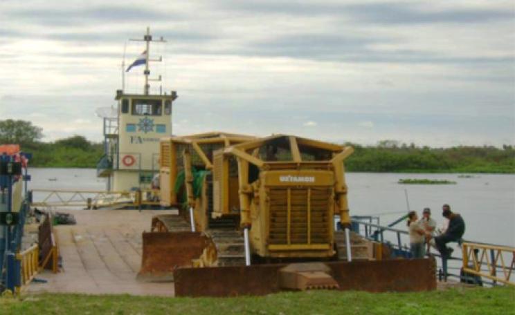 Bulldozer rolling off barge in Paraguay