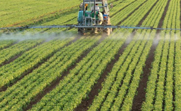Tractor spraying pesticide