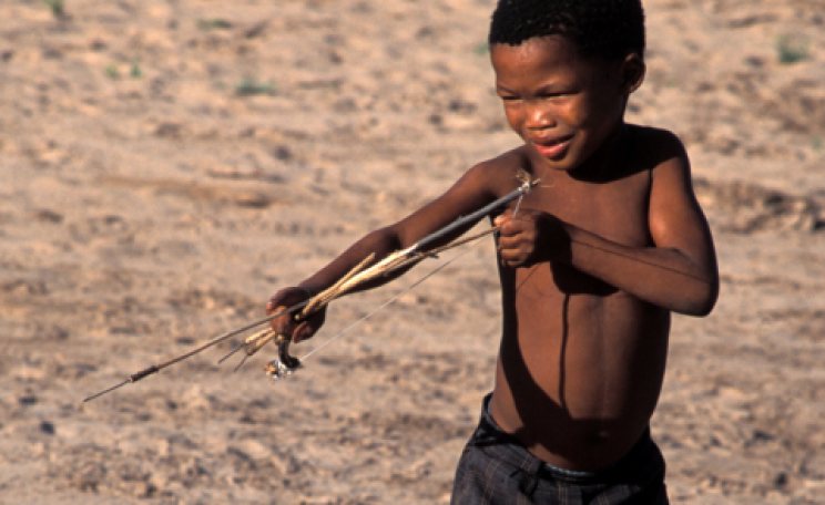 Bushman boy with bow and arrow. Photo: Survival International.