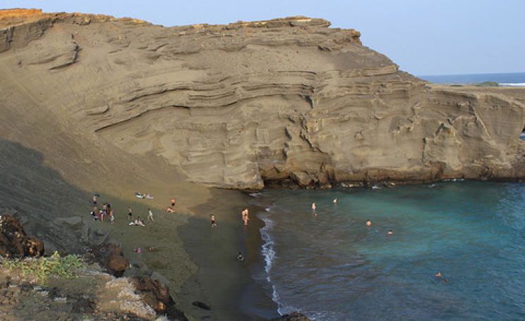 Olivine beach at South Point, Hawaii - as the green-hued rock and sand is weathered by the waves, it sequesters carbon dioxide. Photo: Lauren Bacon via Flickr.com.