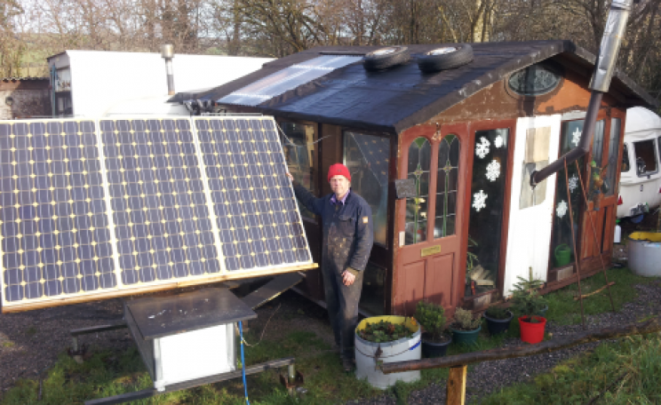 Andy enjoys the sunshine outside 'The Shack' - while solar panels charge up the batteries. Photo: Solar Events.