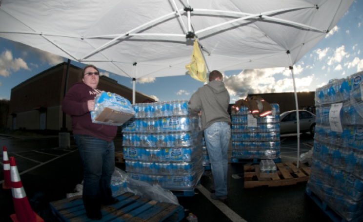 Volunteers Bethany Whisman and Blake Kenney hand out bottled water on Jan. 11, 2014, at Poca High School, W.Va. Photo: Staff Sgt. De-Juan Haley / National Guard via Flickr.com.
