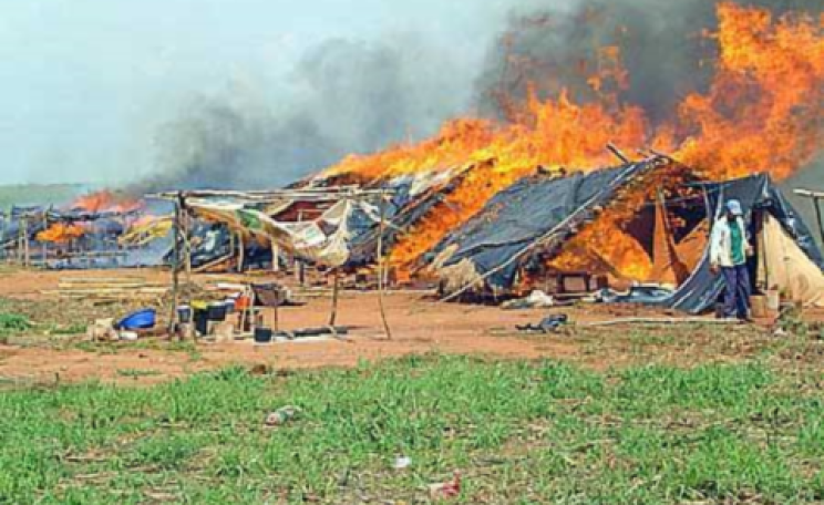An encampment in of rural people evicted by soy barons is bunt out, Paraguay.