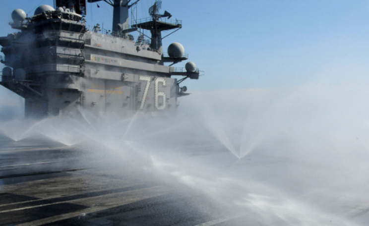 March 23, 2011 - The aircraft carrier USS Ronald Reagan conducts a wash down while the ship is operating off the coast of Japan, to remove potential radiation contamination. U.S. Navy photo by Mass Communication Specialist 3rd Class Kyle Carlstrom.