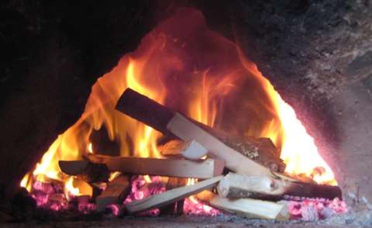 The fire is burning merrily in the cob oven. Photo: Smallholder Training.