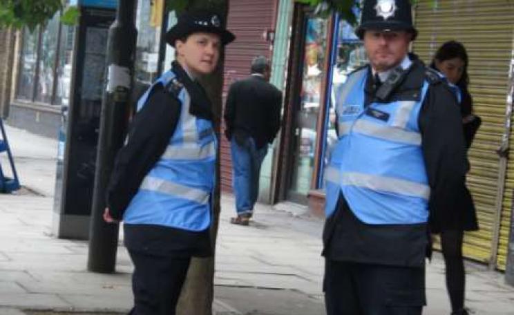 Police Liaison Officers at work - easily recognised by their 'blue bibs'. Just remember what they are there for. Photo: Netpol.