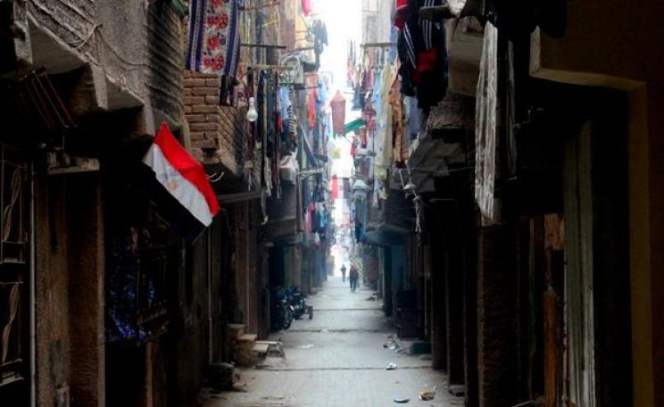 A typically dark, narrow Cairo street in the Boulaq El Dakrour district. Photo: Patrick Keddie.
