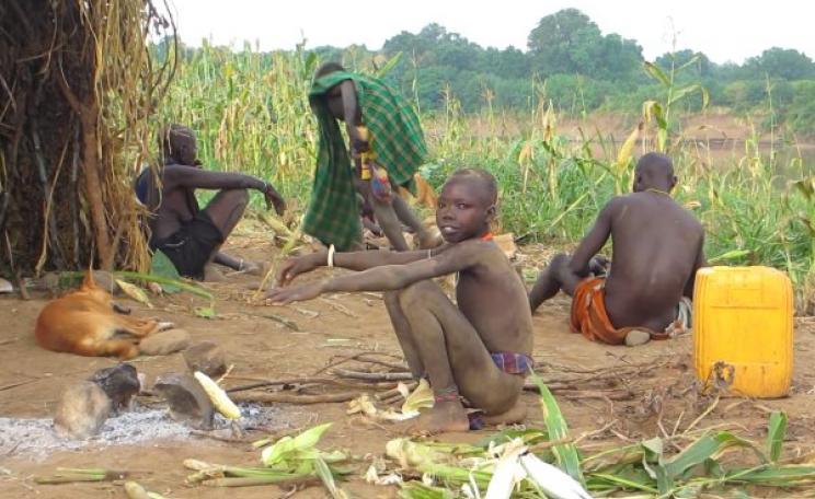 In happier times, a Kwegu family on a maize field next to the Omo river. Photo: via Survival International.