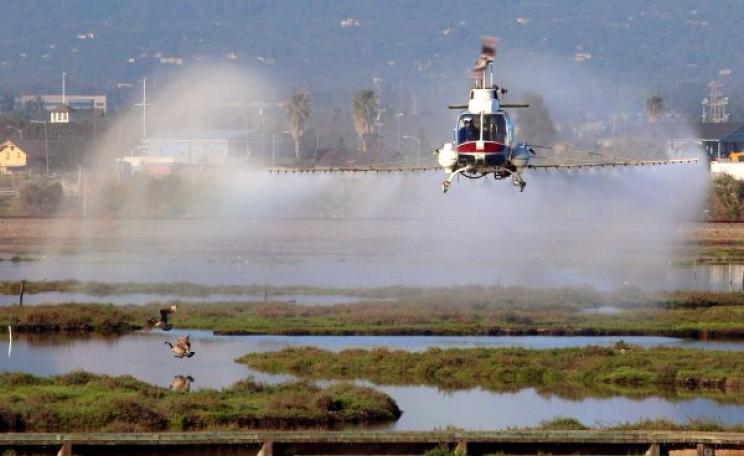 A helicopter of the San Jose Vector Control Agency spraying an unknown pesticide in the Don Edwards National Wildlife Refuge. Photo: Don McCullough via Flickr (CC BY-NC).