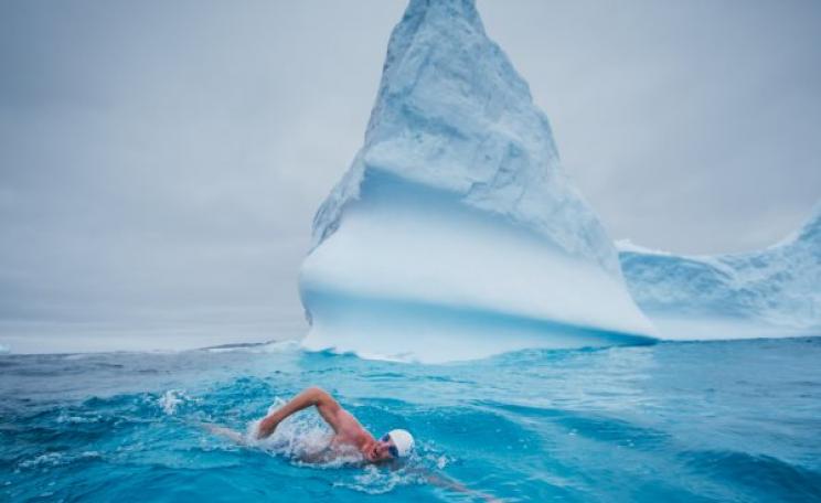 Lewis Pugh swimming 500m in water with a temperature of 0°C off the coast of Peter I Island in the Bellinghausen Sea - one of 13 seas which surround Antarctica. Photo: lewispugh.com.