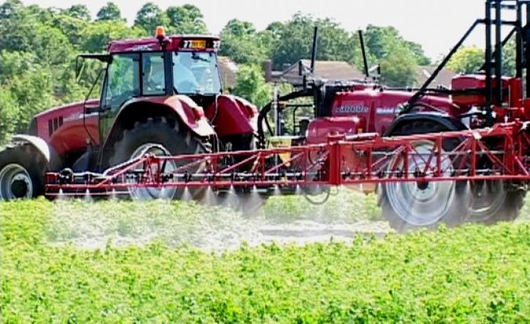 A tractor spraying unknown chemicals in the British countryside. Photo: Billy Ridgers, author provided.