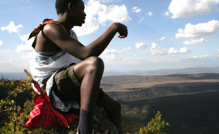 Reuben Sempui seated on a rock on the peak of the volcano Suswa. Photo: Simone Sarchi.
