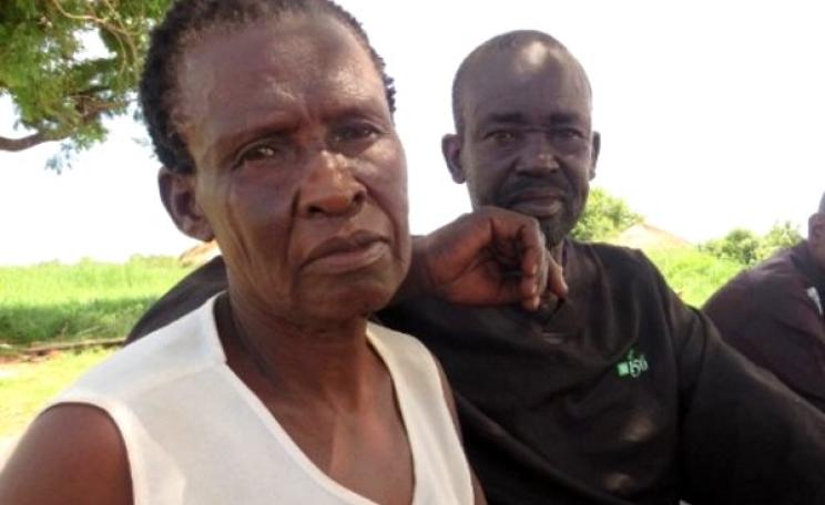 Keromela Anek sits with some of her neighbors in Apaa. Photo: Phil Wilmot / WNV.