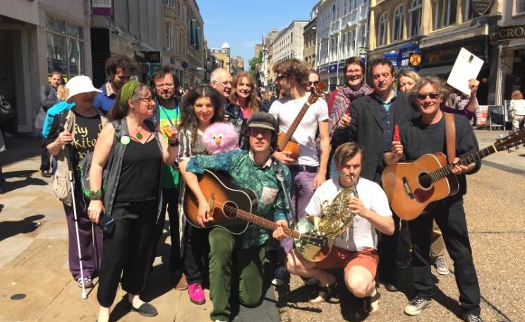 Jonny Walker (centre) and supporters of Keep Streets Live at a 'busk-in' on Oxford's Cornmarket, 27th May 2015, to protest the Labour Council's plans to criminalise busking and other 'non-compliant' behaviour. Photo: Keep Streets Live.