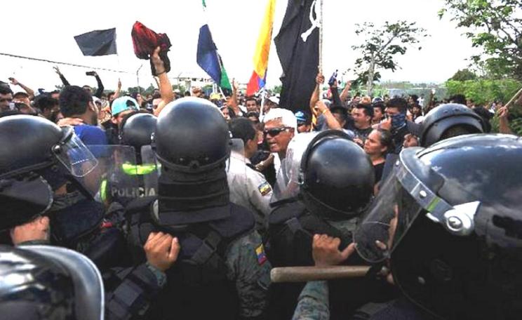 Ex-congressman Eduardo Veliz (white hair) leads a protest at San Cristobál airport, Galapagos, against excessive development, prior to his arrest. Photo: El Colono (Galapagos newspaper).