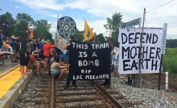 More than a hundred people converged in Ticonderoga, NY on 7th July for a flotilla and symbolic blockade to #StopOilTrains. Photo:  Rising Tide Vermont.
