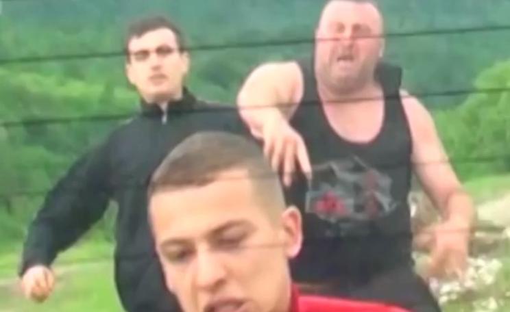 Thugs throwing rocks at illegal timber investigators from Agent Green in Romania, 24th May 2015. Photo: still from video by Agent Green.