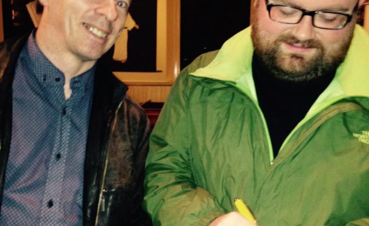 Hero of the hour: Nicky Lowden McCrimmon gives a signature shortly after his victory in defeating a feeble land reform bill, followed by a standing ovation of almost 300 SNP members. Photo: Jen Stout.