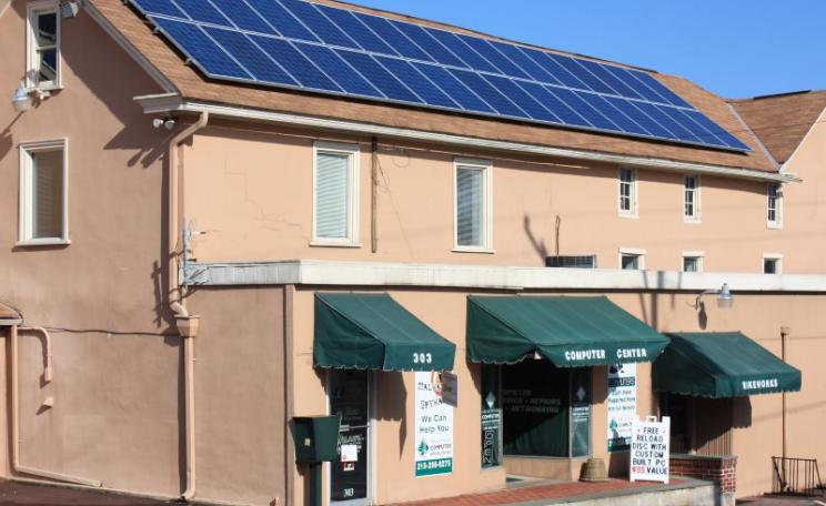 With 50 times more solar power on a 'net metering' basis than now (5% vs 0.1%), electricity costs in Pennsylvania would fall by $25 per customer. Business with solar panels in Harleysville, PA. Photo: Montgomery County Planning Commission via Flickr (CC B