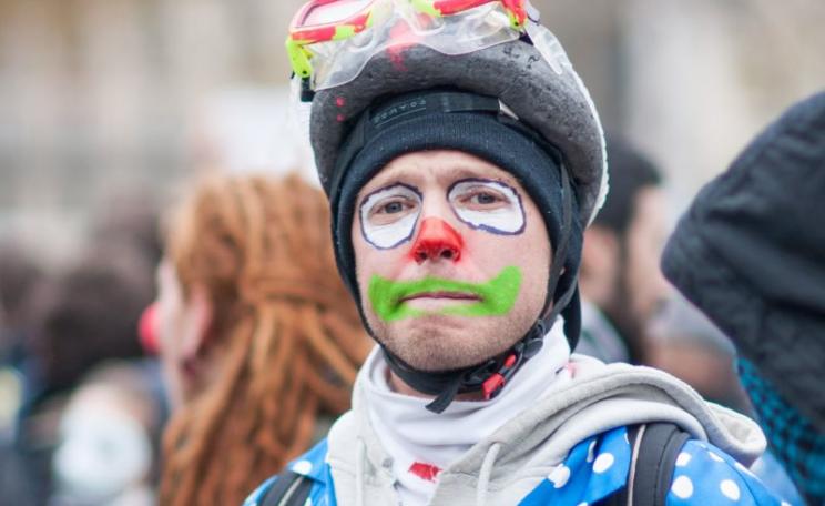 The real clowns are the ones inside the COP21 conference centre, deliberately obstructing and slowing down negotiations. A demonstrator in Paris on 29th November. Photo: Duc via Flickr (CC BY-NC-ND).