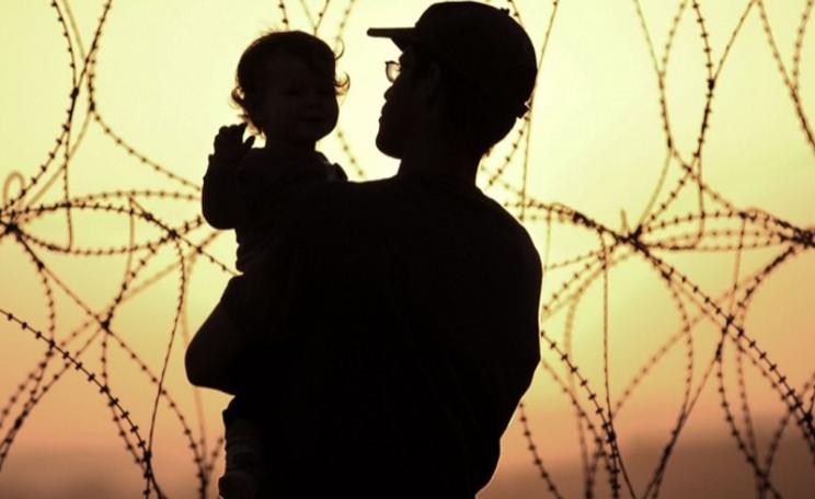 A young Jewish family watch the sun set over the West Bank from their settlement in Occupied Palestine. Photo: Rusty Stewart via Flickr (CC BY-NC-ND).