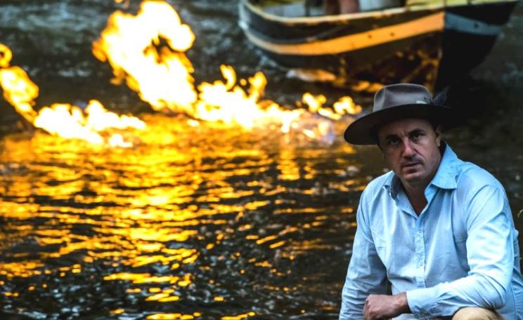 Greens MP Jeremy Buckingham by the burning Condamine River in Queensland, Australia. Photo: Jeremy Buckingham.