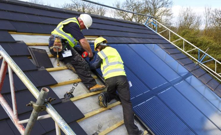 Installing a Solarcentury 'Sunstation', which embeds into the roof rather than sitting above it. Photo: Solarcentury.