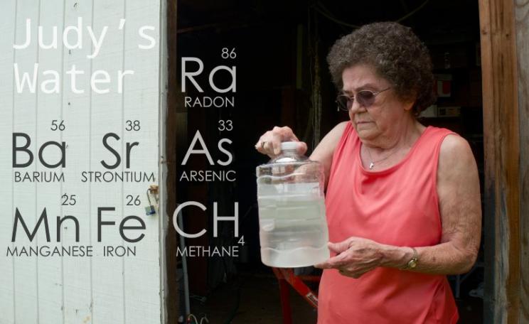 Judy Eckert holding water contaminated with arsenic drawn from her private well 450ft from a fracking rig in Pennsylvania, which she believes contaminated her water supply. Photo: Public Herald via Flickr (CC BY-NC-ND).