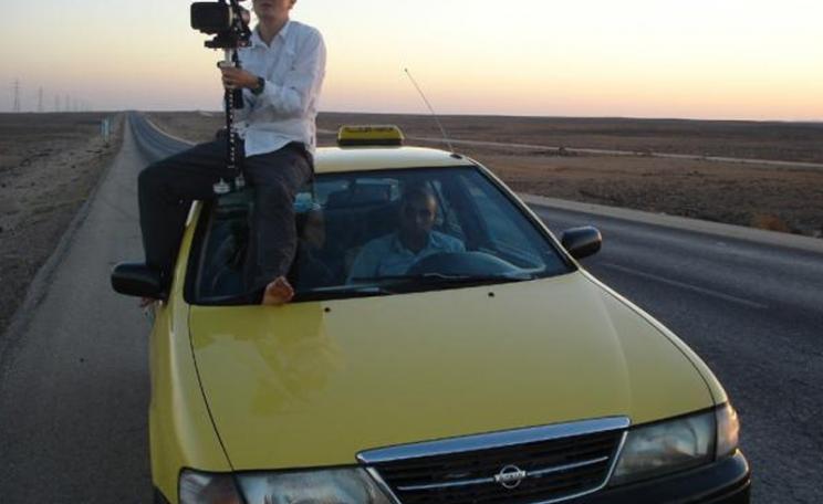 Director Franny Armstrong filming on top of a taxi