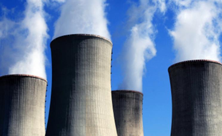 Smoke rises from a nuclear facility's four chimneys
